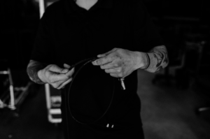 Audiovisual technician wrapping a cable.